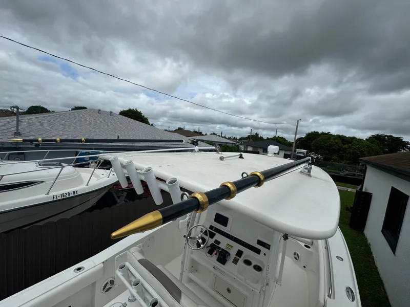 Slide: The Image of 2011 Sea Hunt Gamefish 29 boat with fishing rods, under cloudy sky. - 36