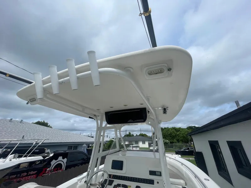 Slide: The Image of 2011 Sea Hunt Gamefish 29 boat with T-top and rod holders under cloudy sky. - 39