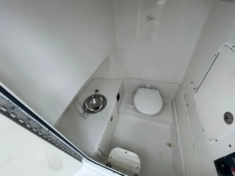 Slide: The Image of 2011 Sea Hunt Gamefish 29 boat interior with toilet and sink. - 44