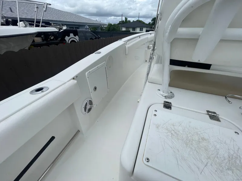 Slide: The Image of 2011 Sea Hunt Gamefish 29 boat interior, featuring white deck and seating area. - 45