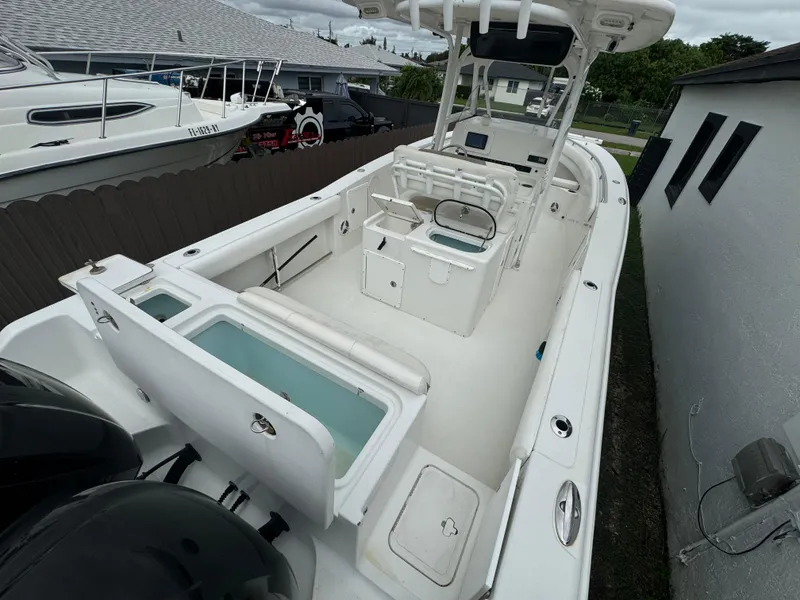 Slide: The Image of 2011 Sea Hunt Gamefish 29 boat with spacious deck and dual outboard motors. - 9