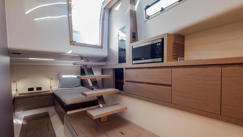 Slide: The Image of Interior of 2022 Pardo Yachts 43, featuring modern wood cabinetry and cozy sleeping area. - 28