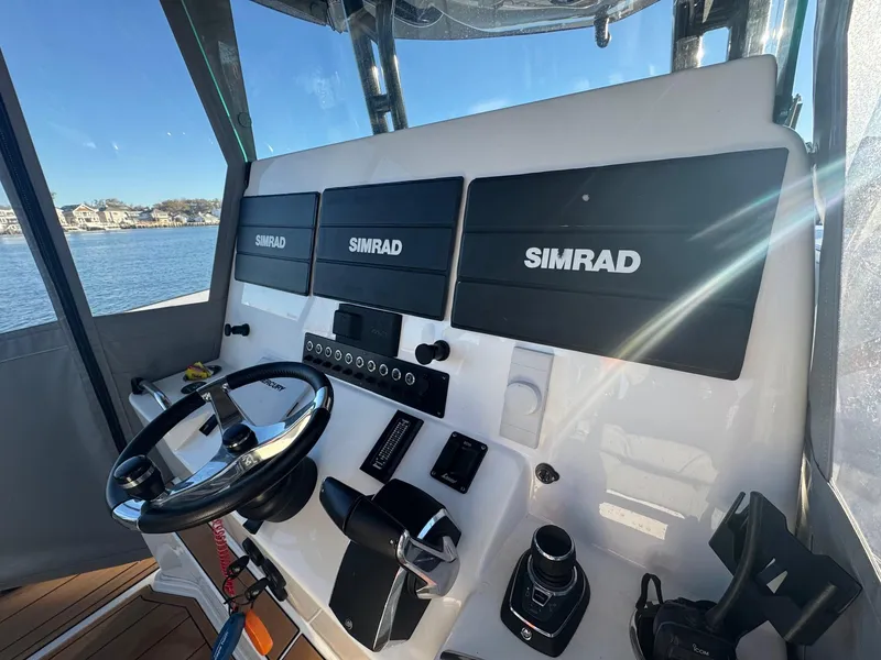 Slide: The Image of 2023 Cape Horn 39T boat with dual engines docked in a serene marina. - 2