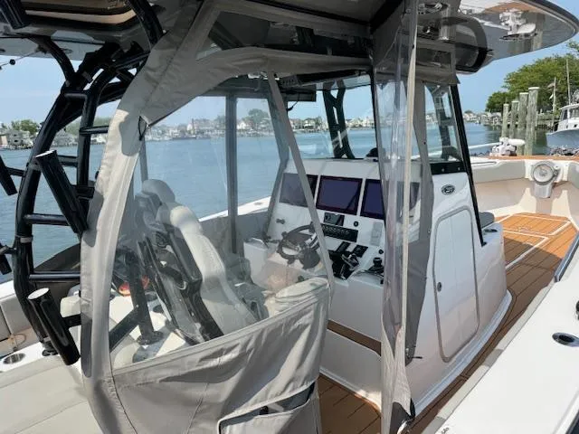 Slide: The Image of 2023 Cape Horn 39T boat with wooden deck, anchored in a serene harbor. - 27