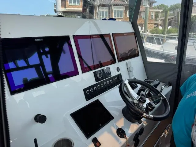 Slide: The Image of 2023 Cape Horn 39T boat docked, featuring teak deck and sleek design. - 23