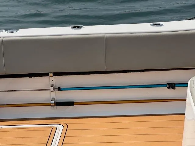 Slide: The Image of 2023 Cape Horn 39T boat on water, with fishing rods and coastal houses in background. - 33