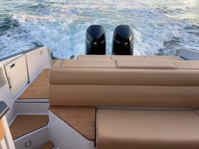 Slide: The Image of 2022 Aviara AV32 OB boat with twin outboard engines on water. - 10