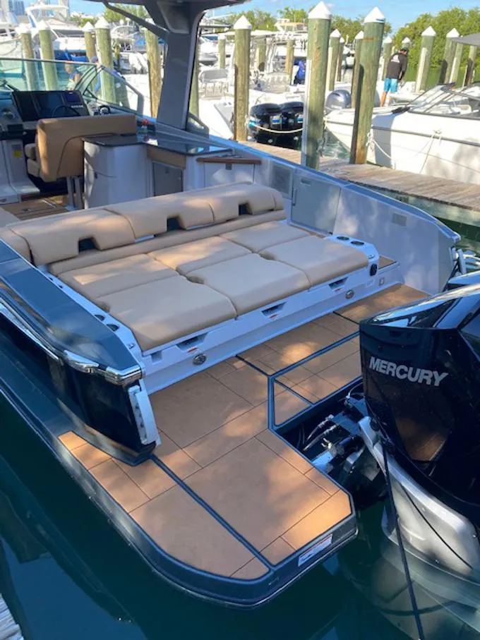 Slide: The Image of 2022 Aviara AV32 OB boat with spacious seating and Mercury outboard engine at marina. - 13