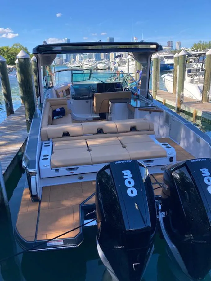 Slide: The Image of 2022 Aviara AV32 OB luxury boat docked with twin Mercury engines. - 14