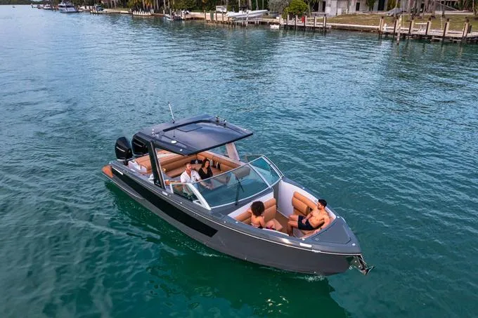 Slide: The Image of 2022 Aviara AV32 OB boat cruising on clear blue water with passengers. - 16