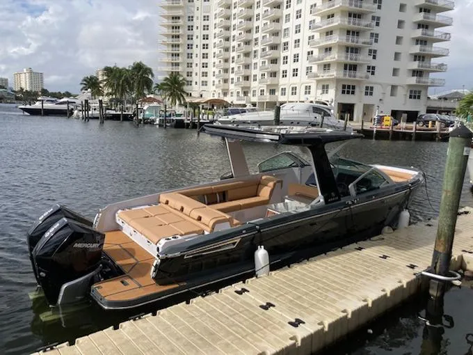 Slide: The Image of 2022 Aviara AV32 OB luxury boat docked by waterfront buildings. - 18