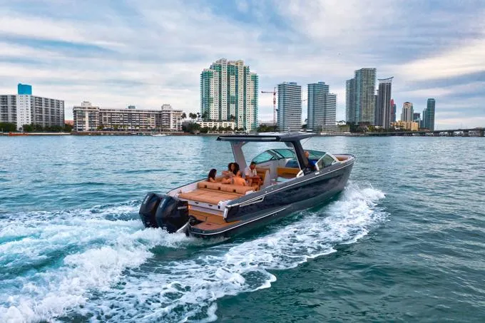 Slide: The Image of 2022 Aviara AV32 OB cruising near city skyline on calm waters. - 20