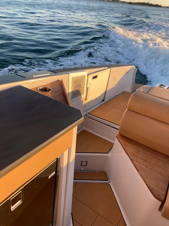 Slide: The Image of 2022 Aviara AV32 OB boat interior with tan seating and ocean view. - 9