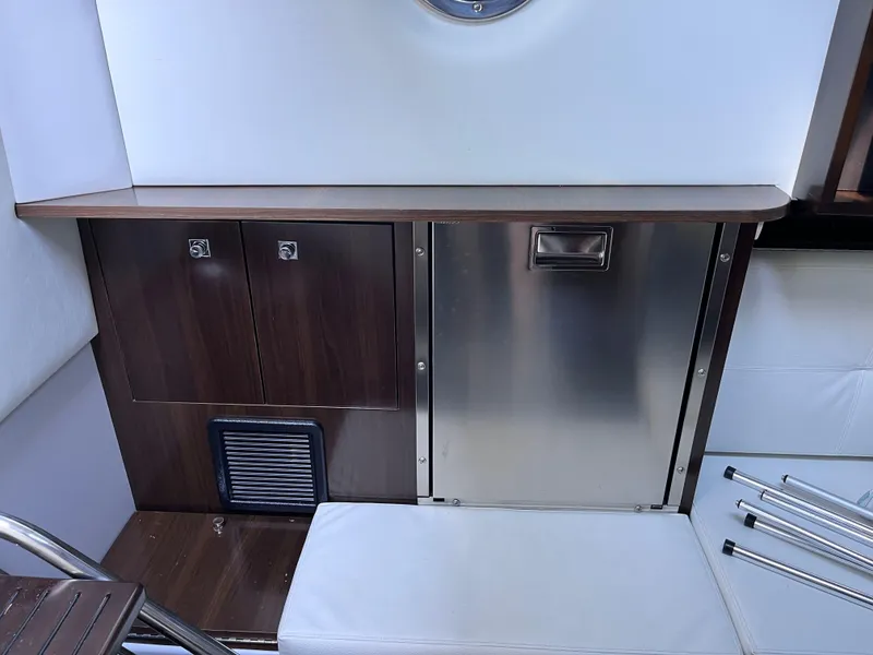 Slide: The Image of Interior of 2021 Cruisers Yachts 338 CX IO, featuring sleek cabinetry and stainless steel accents. - 12