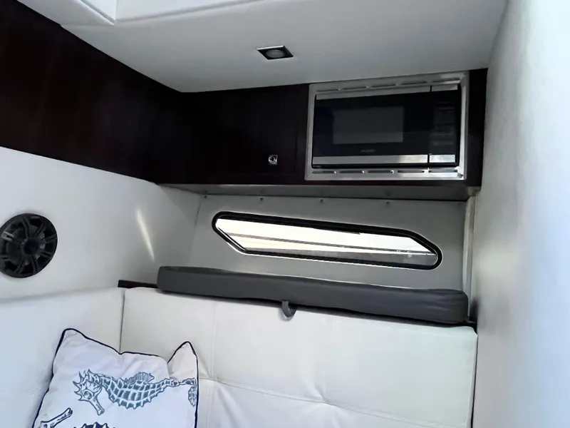 Slide: The Image of Interior of 2021 Cruisers Yachts 338 CX IO with microwave and seating area. - 14