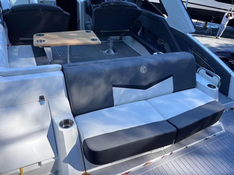 Slide: The Image of 2021 Cruisers Yachts 338 CX IO interior with seating and table, showcasing luxury design. - 4