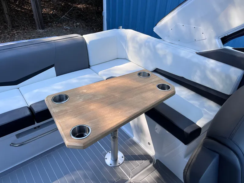 Slide: The Image of 2021 Cruisers Yachts 338 CX IO interior with seating and wooden table. - 6