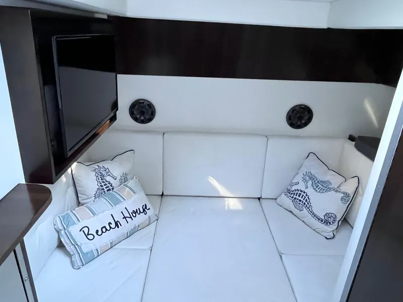 Slide: The Image of Interior of 2021 Cruisers Yachts 338 CX IO with cozy seating and decorative pillows. - 15