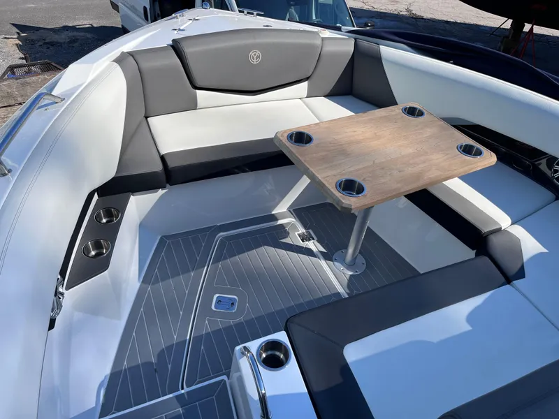 Slide: The Image of 2021 Cruisers Yachts 338 CX IO interior with seating and wooden table. - 18