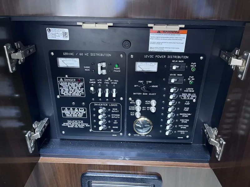 Slide: The Image of Electrical panel of 2021 Cruisers Yachts 338 CX IO, showcasing power distribution controls. - 19