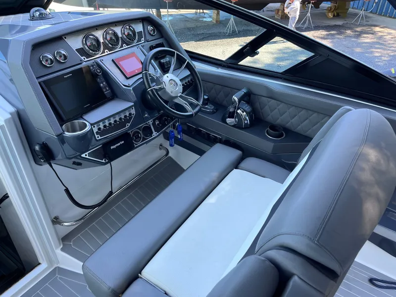 Slide: The Image of 2021 Cruisers Yachts 338 CX IO helm with modern controls and luxurious seating. - 7