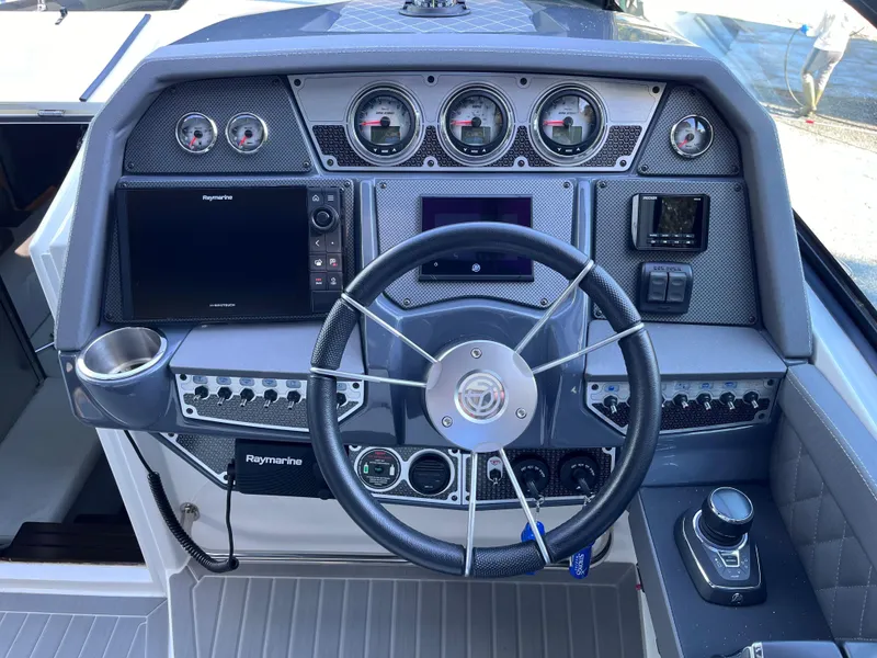 Slide: The Image of 2021 Cruisers Yachts 338 CX IO dashboard with steering wheel and navigation controls. - 8