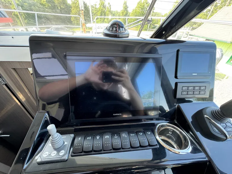 Slide: The Image of 2025 Jeanneau NC 895 Series 2 helm with Garmin display and control panel. - 13