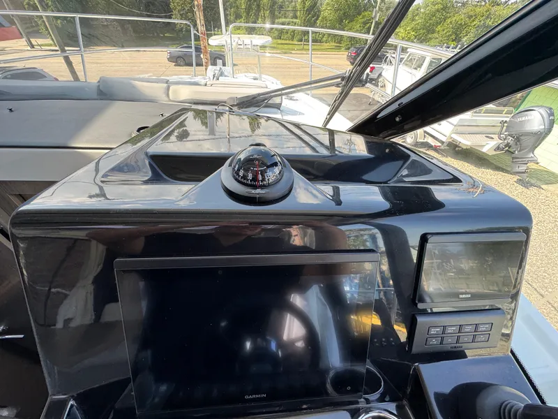 Slide: The Image of 2025 Jeanneau NC 895 Series 2 helm with compass and navigation display. - 14