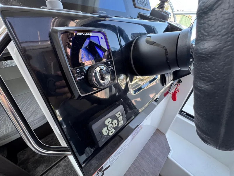 Slide: The Image of Control panel of 2025 Jeanneau NC 895 Series 2 boat with steering wheel and electronics. - 15