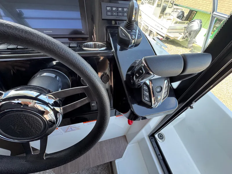 Slide: The Image of 2025 Jeanneau NC 895 Series 2 helm with steering wheel and control panel. - 16