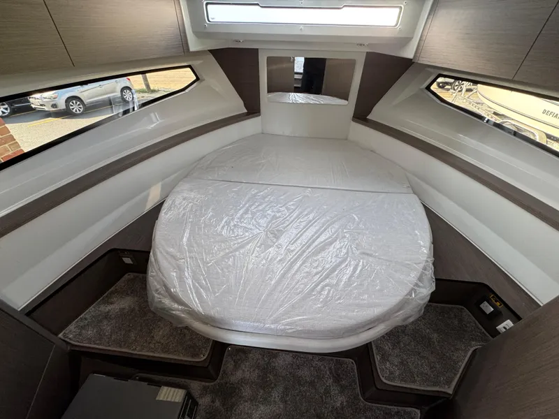 Slide: The Image of Interior cabin of 2025 Jeanneau NC 895 Series 2 with bed and windows. - 18