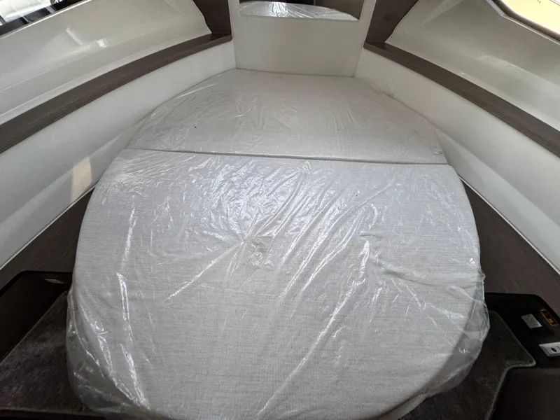 Slide: The Image of Interior cabin of 2025 Jeanneau NC 895 Series 2 boat, featuring a covered bed. - 19