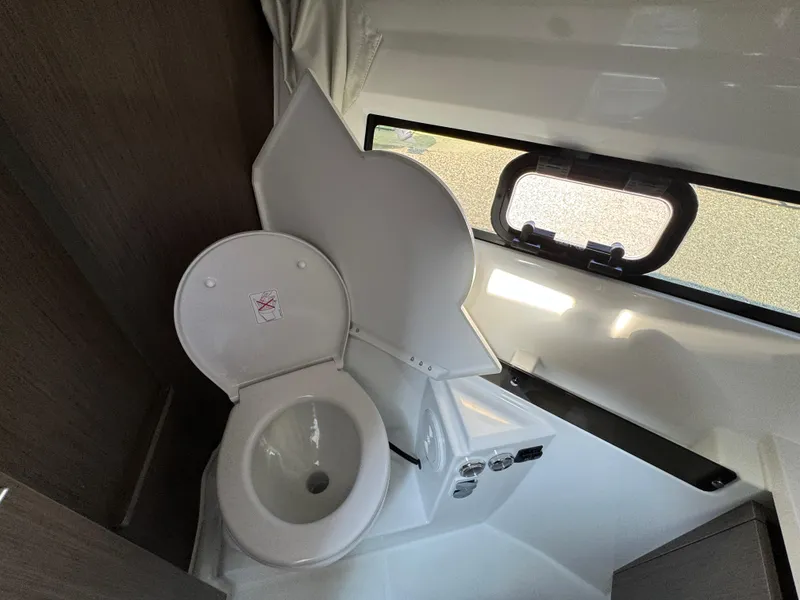 Slide: The Image of 2025 Jeanneau NC 895 Series 2 bathroom with compact toilet and window. - 23
