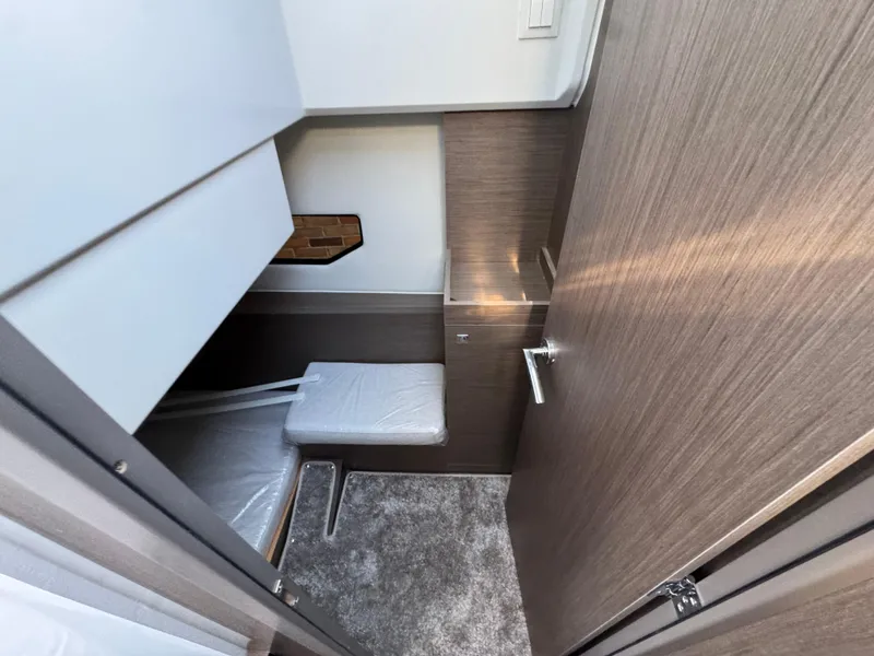 Slide: The Image of 2025 Jeanneau NC 895 Series 2 cabin interior with modern wood finish and compact design. - 25
