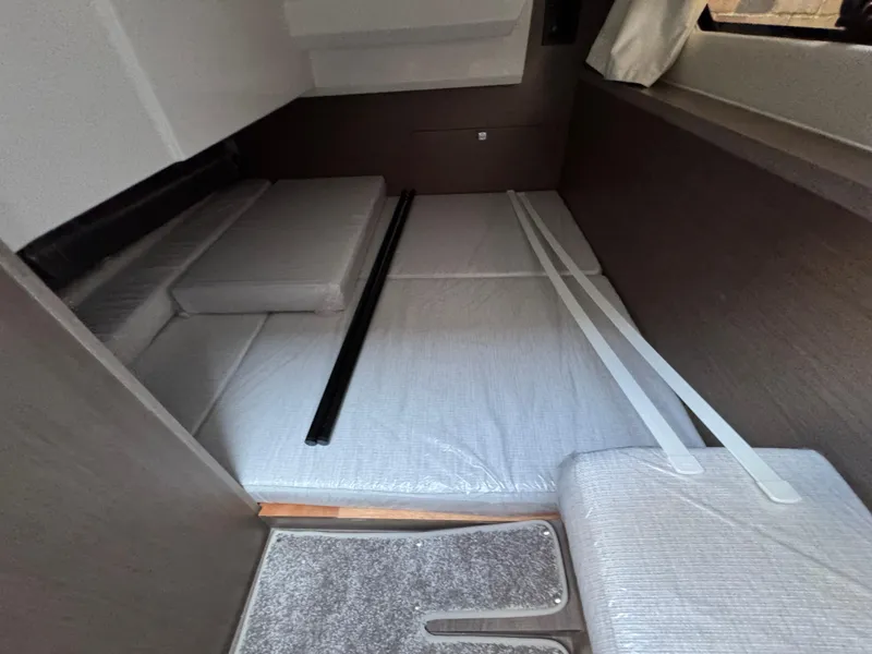 Slide: The Image of Interior cabin of 2025 Jeanneau NC 895 Series 2, featuring a compact sleeping area. - 26