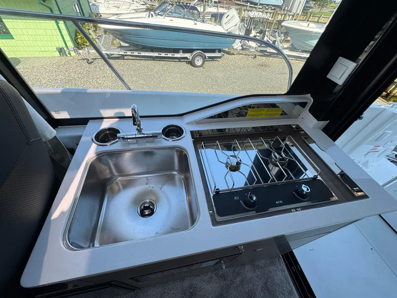 Slide: The Image of 2025 Jeanneau NC 895 Series 2 boat kitchen with sink and stove. - 28