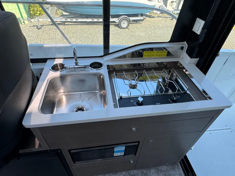 Slide: The Image of 2025 Jeanneau NC 895 Series 2 boat kitchen with sink and stove. - 7