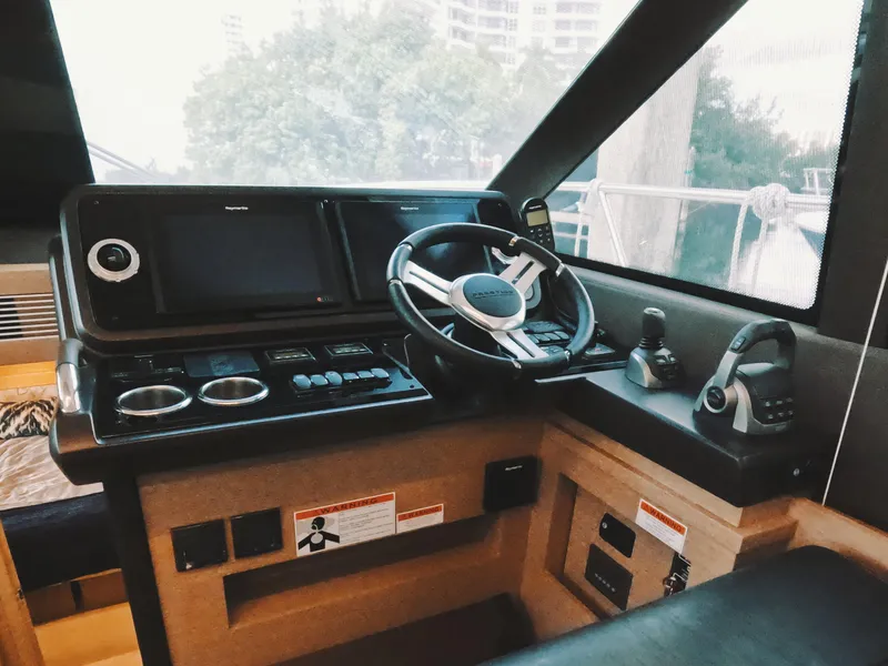 Slide: The Image of Prestige 460 yacht helm, 2020 model, featuring modern navigation controls and steering wheel. - 27
