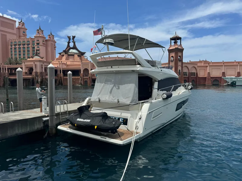 Slide: The Image of Prestige 460 yacht docked at marina, 2020 model, with scenic architecture in background. - 7