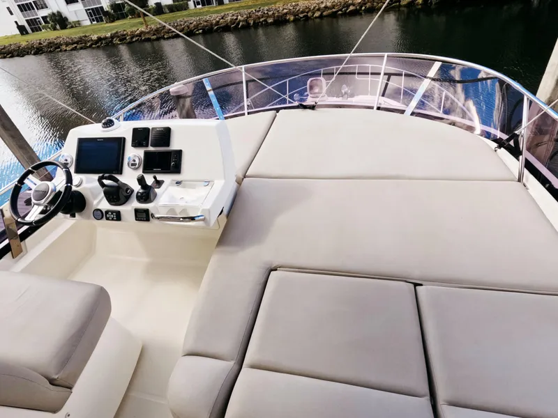 Slide: The Image of Prestige 460 yacht helm and seating area, 2020 model, overlooking calm waters. - 9