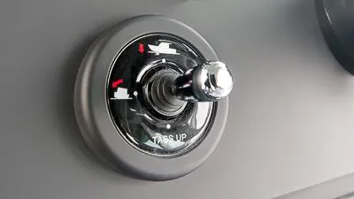 Slide: The Image of Axopar 37 XC BRABUS 2024 trim control knob, labeled "TABS UP." - 12