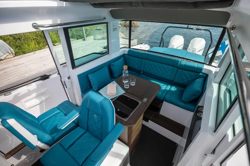 Slide: The Image of Luxurious interior of 2024 Axopar 37 XC BRABUS with wet bar and turquoise seating. - 15