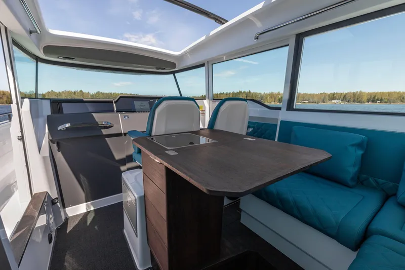 Slide: The Image of Interior of 2024 Axopar 37 XC BRABUS with wet bar and seating area. - 17