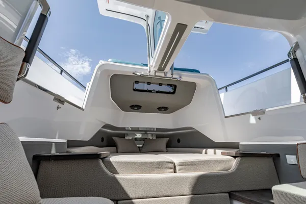 Slide: The Image of Interior of 2024 Axopar 37 XC BRABUS Trim Wet Bar, featuring modern seating and open roof. - 24