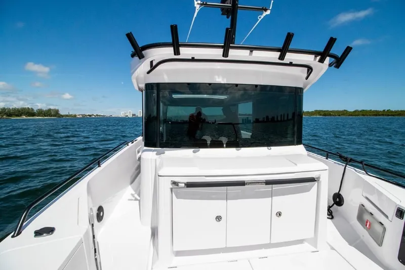 Slide: The Image of 2024 Axopar 37 XC BRABUS Trim Wet Bar on open water, featuring sleek design and modern amenities. - 4