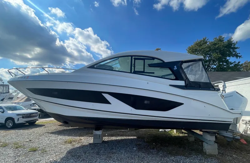 The Image of 2024 Beneteau Gran Turismo 32 yacht displayed outdoors under a partly cloudy sky. - 0