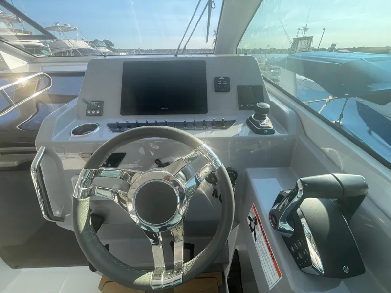Slide: The Image of Helm of 2024 Beneteau Gran Turismo 32 yacht with modern controls and steering wheel. - 10