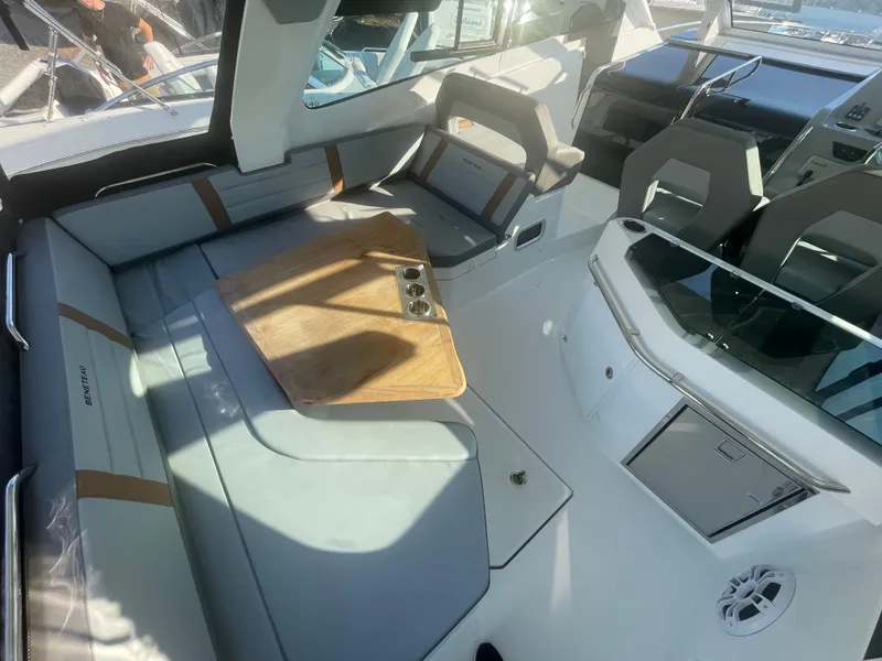 Slide: The Image of 2024 Beneteau Gran Turismo 32 interior with modern seating and wooden table. - 11