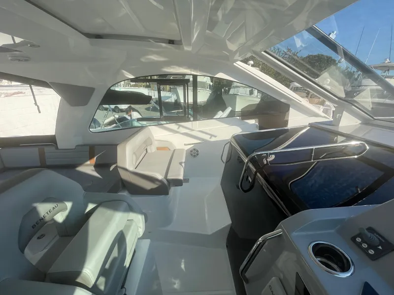 Slide: The Image of 2024 Beneteau Gran Turismo 32 interior with modern helm and seating area. - 24