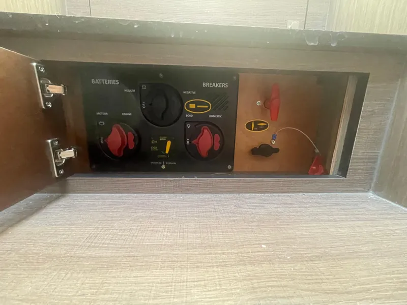 Slide: The Image of Control panel of 2024 Beneteau Gran Turismo 32, featuring battery and breaker switches. - 27